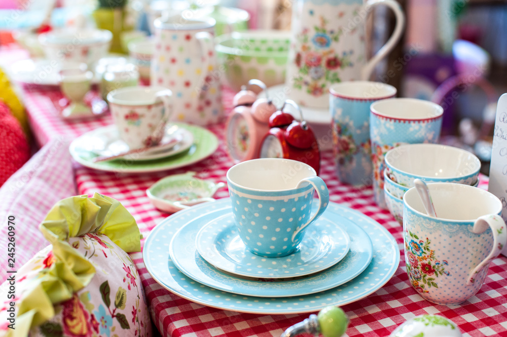Colored cups and plates an a table Colored cups and plates an a table