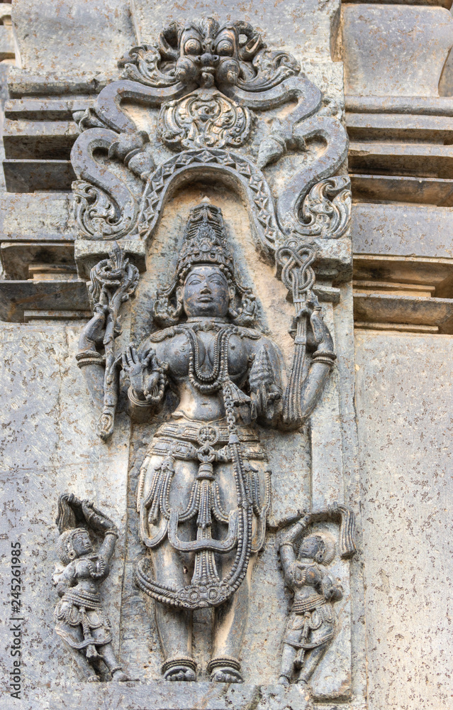 Belur, Karnataka, India - November 2, 2013: Chennakeshava Temple building. Black stone statue of female figure called Mohini, avatar of Lord Vishnu.