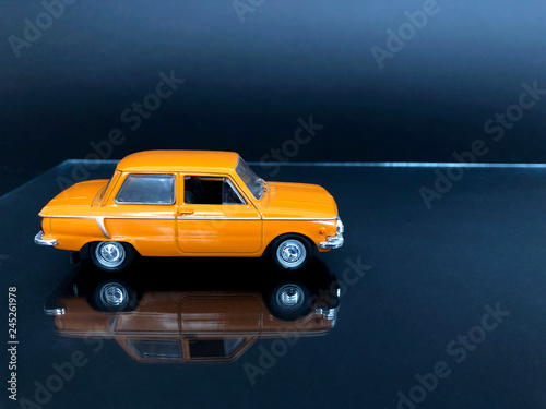 orange car on a dark background © plastilin01