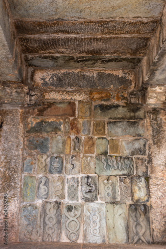 Belur, Karnataka, India - November 2, 2013: Chennakeshava Temple building. Wall under mandapam with multiple stone sculptures of intertwined snakes, symbol of Tamas, the destructive tendency, associat
