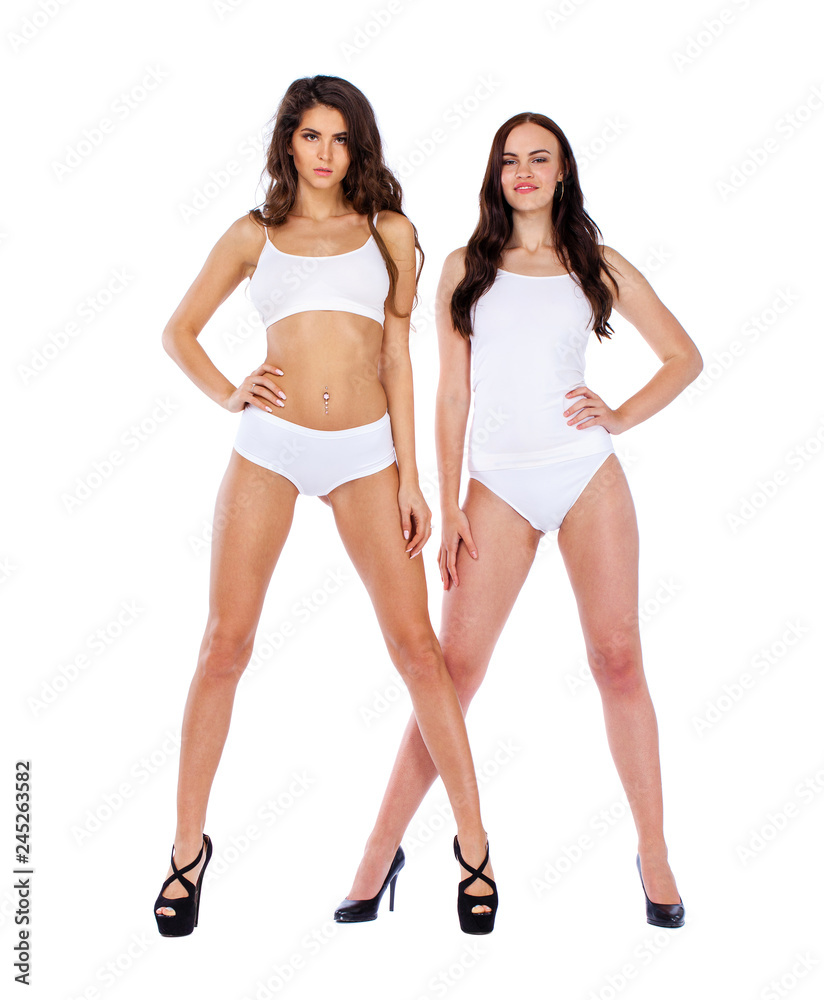 Fitness women. Two young beautiful girlfriends in white sportswear Fitness women. Two young beautiful girlfriends in white sportswear
