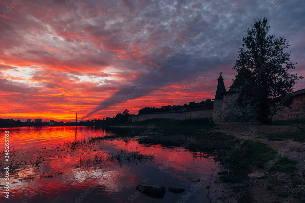 Crimson sunset above Pskov fortress watch towers