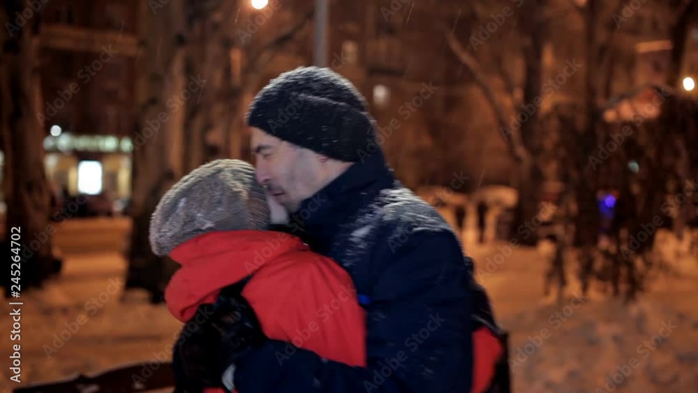 A young man and woman met on a winter evening in the park. Happy couple relationship A young man and woman met on a winter evening in the park. Happy couple relationship