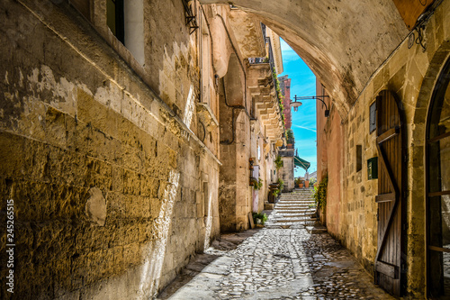 A covered alley leads to a cafe and piazza in the ancient city of Matera, Italy © Kirk Fisher