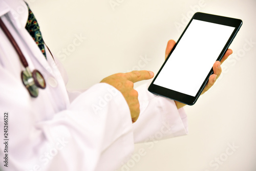 Close-up of doctor hands using smartphone for order antibiotic in hospital network or social networks concept, man typing an sms message to his friends.