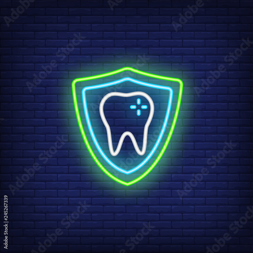 Tooth with protection shield neon sign. Stomatology and dental clinic advertisement design. Night bright neon sign, colorful billboard, light banner. Vector illustration in neon style.
