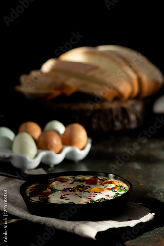 baked eggs with fresh eggs and sliced bread