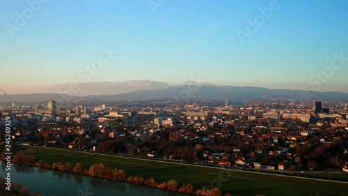 Beautiful panorama of Zagreb and Sava River at sunset with mountains on the background. Zagreb Croatia. Aerial view traveling photo