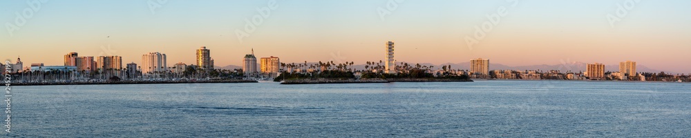 Panorama of Long Beach harbor as seen from a boat at sunset.