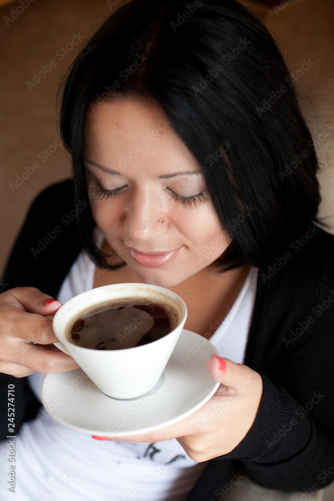 young woman sitting in a cafe drinking coffee young woman sitting in a cafe drinking coffee