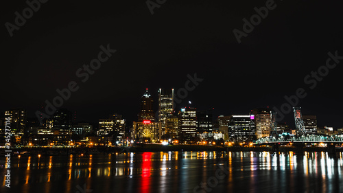 Nighttime Cityscape Across Water with Reflections