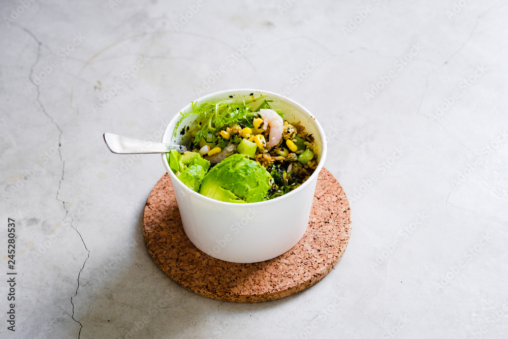 Take away salad in disposable white paper bowl on white table. Minimalism food photography concept. Mockup, copyspace, vertical Take away salad in disposable white paper bowl on white table. Minimalism food photography concept. Mockup, copyspace, vertical