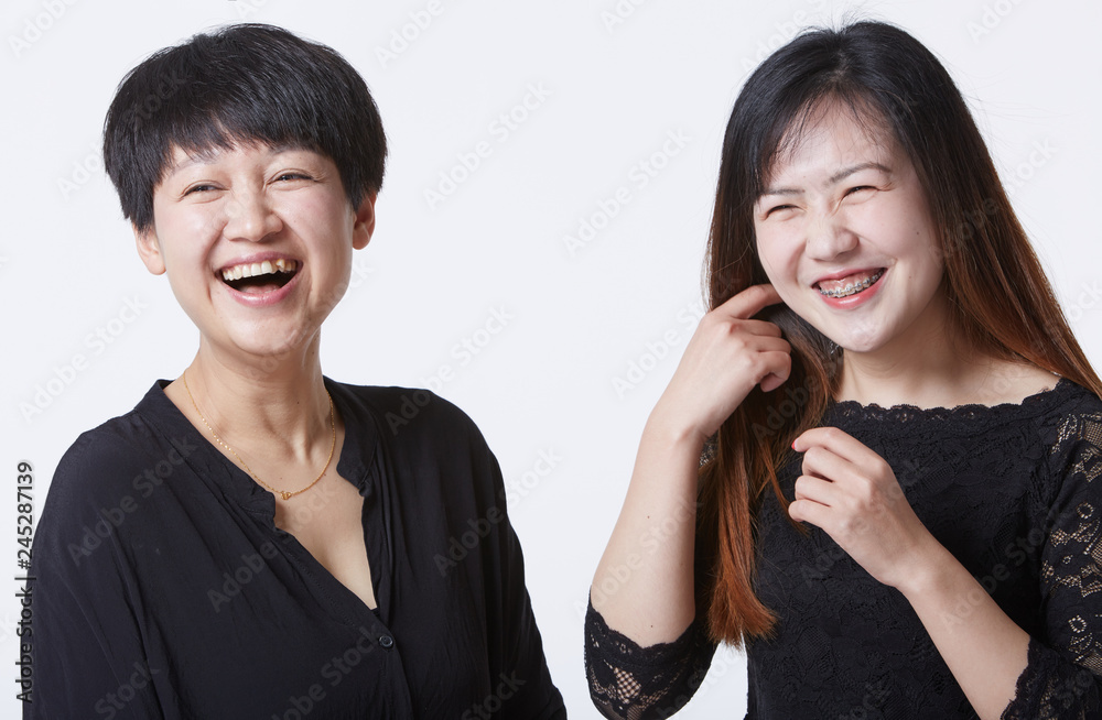Asian portrait, photo with sisters. Indoors white background Asian portrait, photo with sisters. Indoors white background