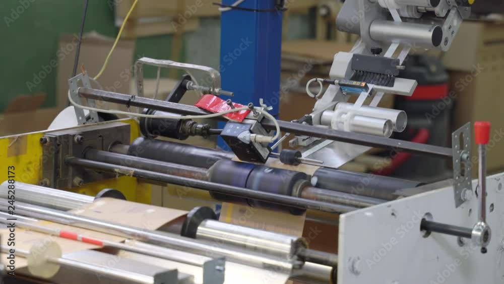 Production process of applying adhesive tape on paper bags.
Production process of applying adhesive tape on paper bags.