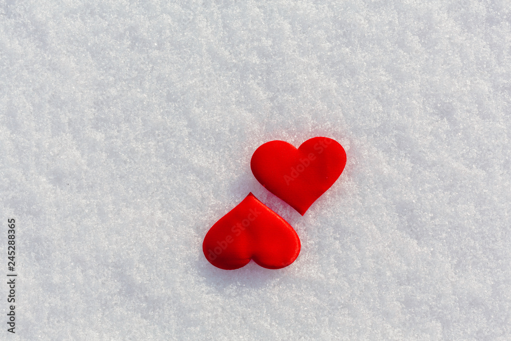 Two red hearts on glittering snow. Vilentine's day theme. Two red hearts on glittering snow. Vilentine's day theme.