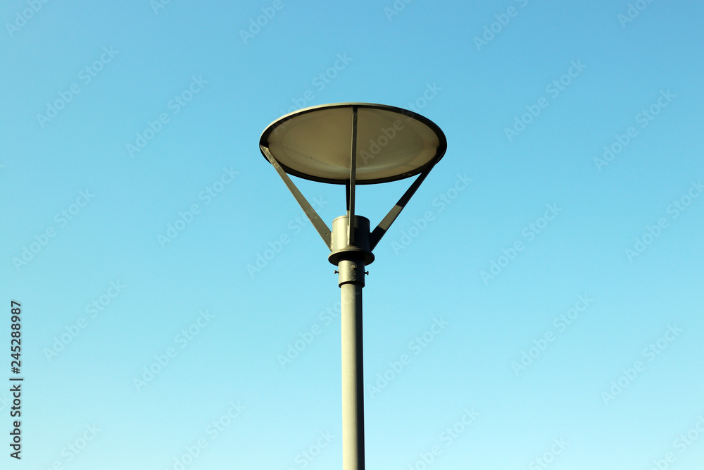 A round street lamp against the blue sky A round street lamp against the blue sky