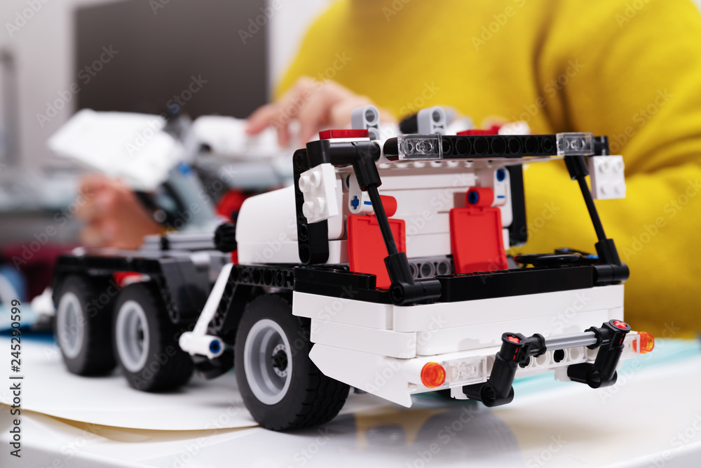 car assembly kit, woman assemble a very complicated and common car truck toy. car assembly kit, woman assemble a very complicated and common car truck toy.