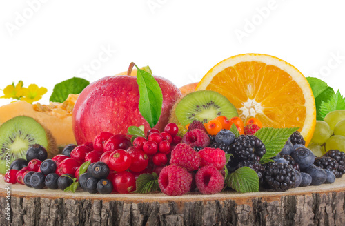 heap of berries and fruits  on wooden stump isolated on white background