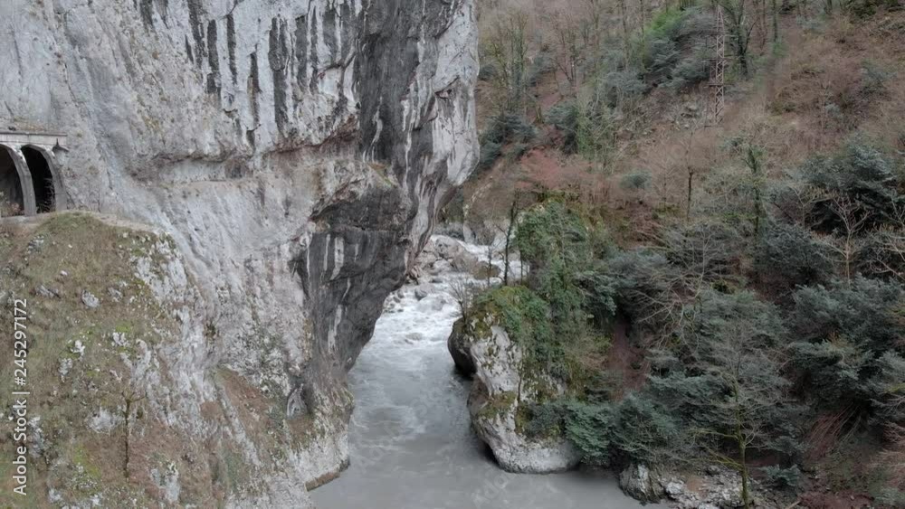 Aerial view of mountain river in Ahcy gorge after rain. Autumn fall forest. Abandoned road to Krasnaua Polyana, Sochi. Mountain valley. Aerial view of mountain river in Ahcy gorge after rain. Autumn fall forest. Abandoned road to Krasnaua Polyana, Sochi. Mountain valley.