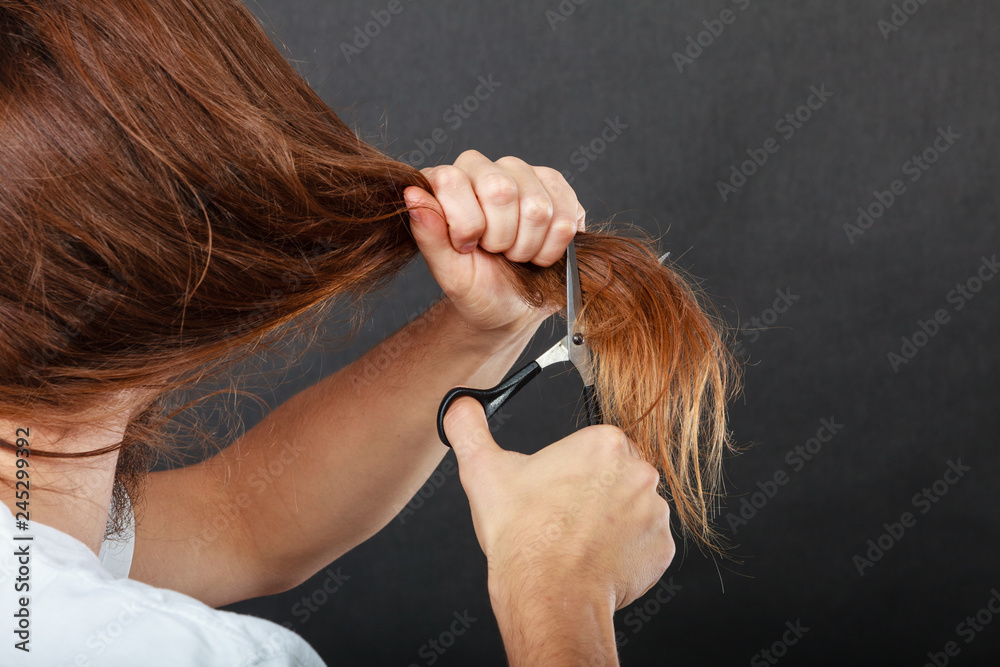 Fototapeta premium Male hands cutting long hair