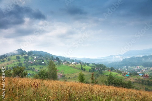 Beautiful mountain summer landscape. Mountain peaks misty morning.