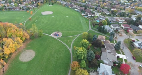 Flying Towards Childrens Playground Near Soccer Field In Park In Neighborhood Aerial photo