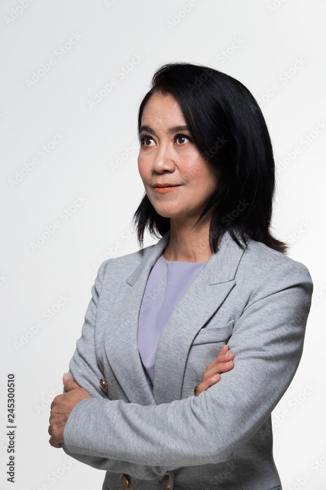 Asian 50s 60s years old Business Woman Stand in gray Formal Suit pants , studio lighting grey background isolated, Senior Boss female with short hair eyes hands happy smile look direction Asian 50s 60s years old Business Woman Stand in gray Formal Suit pants , studio lighting grey background isolated, Senior Boss female with short hair eyes hands happy smile look direction
