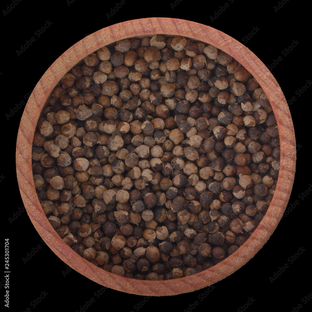 monk's pepper in wooden cup isolated on black background. top view monk's pepper in wooden cup isolated on black background. top view