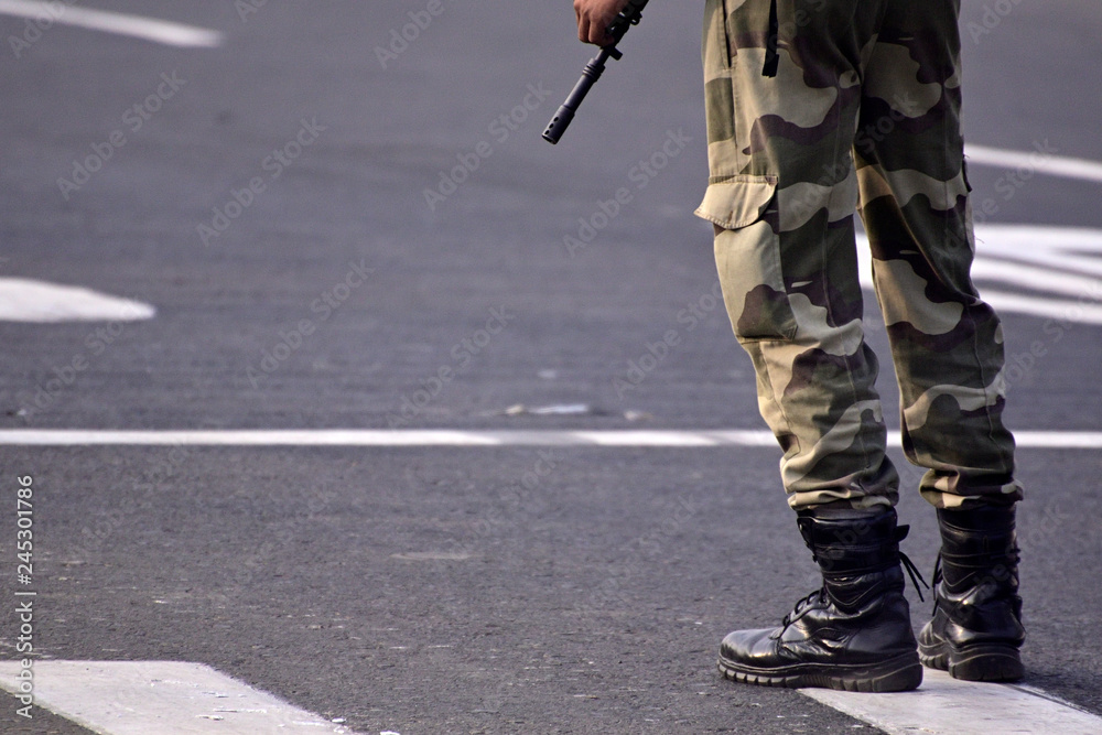 Security guard with rifle standing on outside to protect the area. Security guard with rifle standing on outside to protect the area.