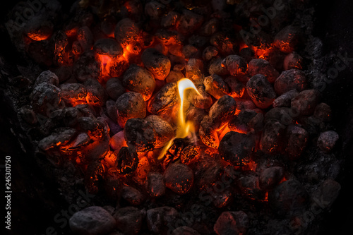 Photographie Coals of a bonfire burning at night .