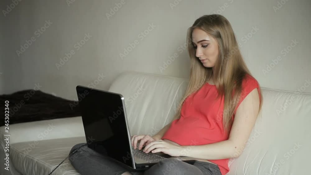 Home office - pregnant woman working with laptop Home office - pregnant woman working with laptop