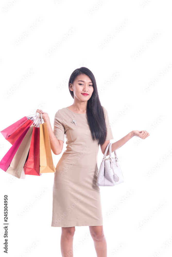 Cheerful shopping woman of Asian descent holding bags. Shopping smart business woman happy smiling holding colorful shopping bags isolated on white . Fresh young Asian female model Cheerful shopping woman of Asian descent holding bags. Shopping smart business woman happy smiling holding colorful shopping bags isolated on white . Fresh young Asian female model