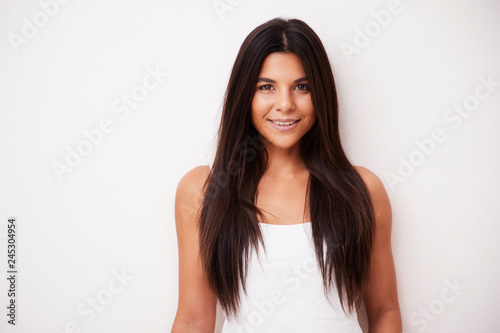 Portrait of beautiful brunette smiling to camera © sanneberg