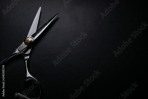 Valokuvatapetti professional scissors on black background