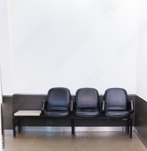 Black leather bench seat row on white wall background in waiting area. Architectural Home or Office Interior, House Furniture, Life and Living, Lifestyle, Decoration, Idea and Minimal Design concept