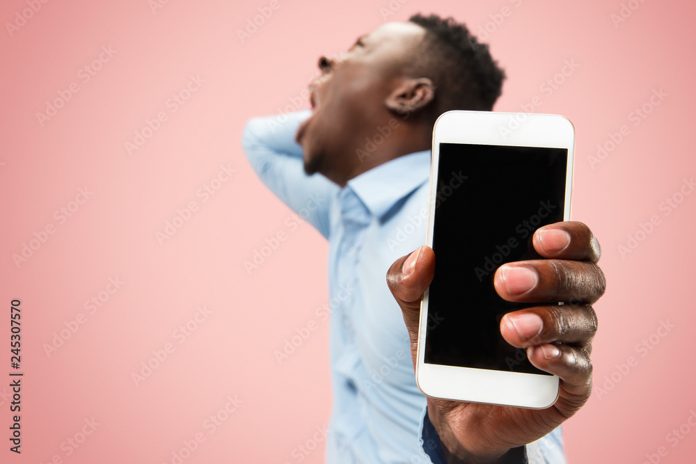Why is that. Beautiful male half-length portrait isolated on trendy pink studio backgroud. Young emotional surprised, frustrated and bewildered man. Human emotions, facial expression concept. Why is that. Beautiful male half-length portrait isolated on trendy pink studio backgroud. Young emotional surprised, frustrated and bewildered man. Human emotions, facial expression concept.
