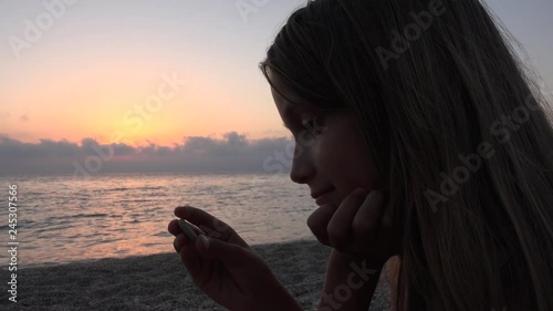 Child on Beach, Kid Playing on Shore in Sunset, Girl Watching Studying Pebbles