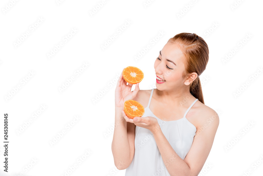 Natural Beauty Portrait. Beautiful smile Spa Woman . Perfect Fresh Skin.Portrait of the young asian beautiful girl with orange fruit in hand , isolated on white background Natural Beauty Portrait. Beautiful smile Spa Woman . Perfect Fresh Skin.Portrait of the young asian beautiful girl with orange fruit in hand , isolated on white background