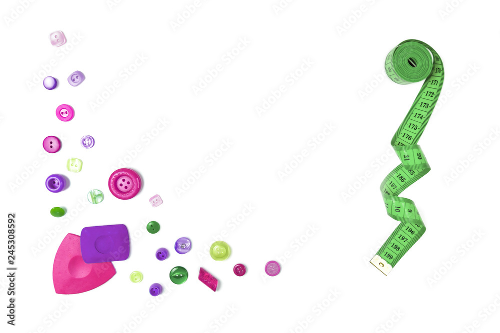 Sewing accessories (a centimetric measuring tape, a set of buttons, swept for fabric) on the white isolated background. The place for a text inscription Sewing accessories (a centimetric measuring tape, a set of buttons, swept for fabric) on the white isolated background. The place for a text inscription