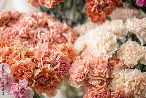 carnation flowers of different varieties and colors. Bunch pastel color. the concept of a florist in a flower shop. Wallpaper. © malkovkosta