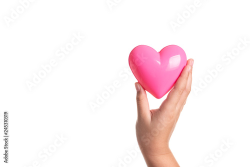 Pink heart on kid hand isolated on white
