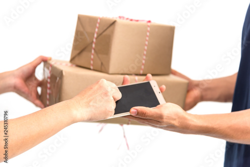 Carrier man delivered products boxes to customer to Home , Messenger delivery man gives cellphone application for signs and takes boxes. Isolate on white background.Technology for e-business for sale photo