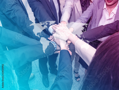 Fototapeta Naklejka Na Ścianę i Meble -  Teamwork Join Hands Support Together in cafe Concept,top Angle View Of Multiracial Business people Stacking Hands Over Each Other with world map, Element of this image furnished by Nasa