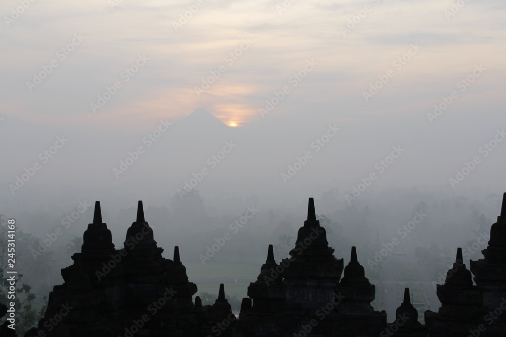 Silhouette Borobudur Temple with the mysteries forest surrounding at dawn, Yogyakarta, Indonesia