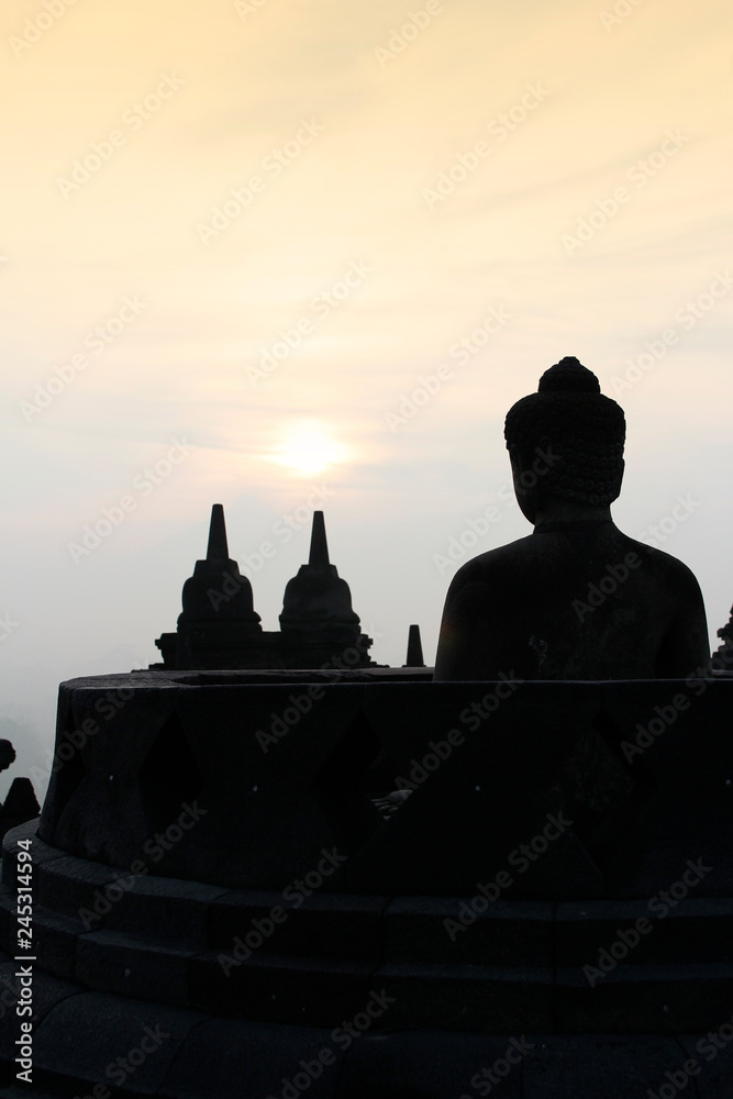 Silhouette Borobudur Temple with the Buddha statue during sunrise, Yogyakarta, Indonesia