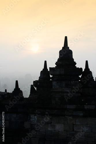 Silhouette Borobudur Temple with the mysteries forest surrounding at dawn, Yogyakarta, Indonesia © Crystaltmc