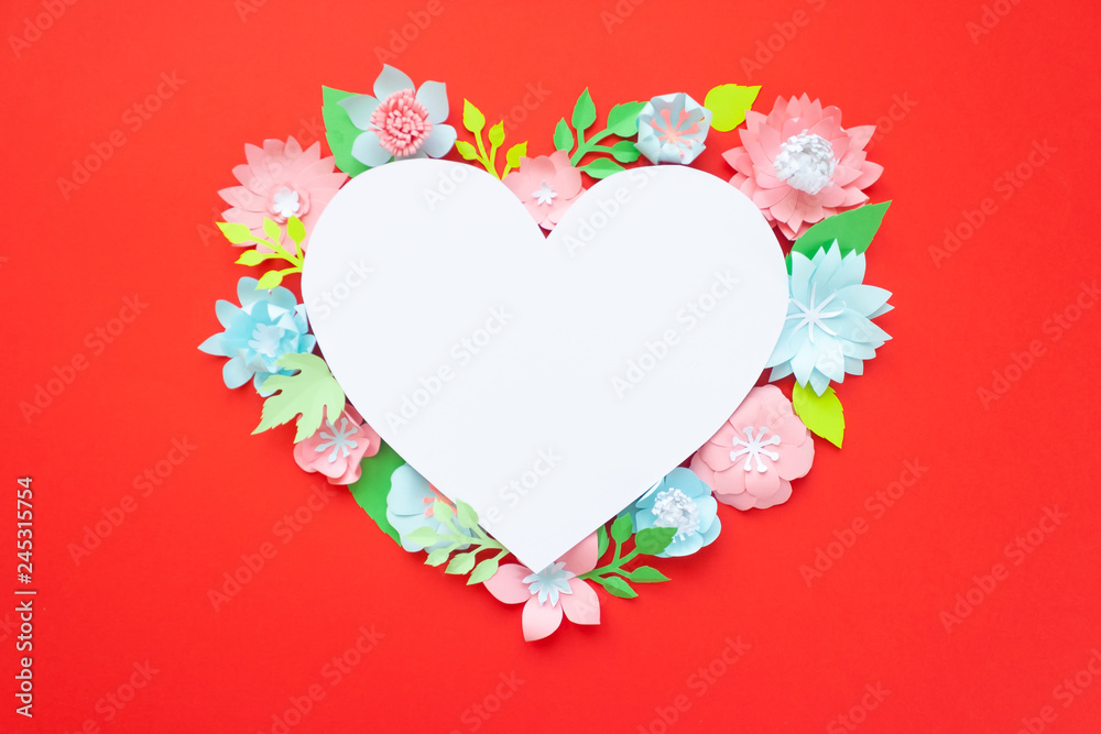 Heart frame with paper flowers on red background. Cut from paper.