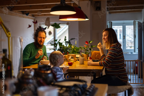 Family having breakfast together during the morning at the kitchen.