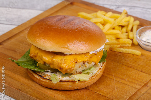 Homemade burger with fish, cheese and salad leaves
