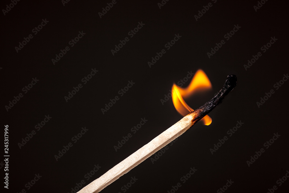 matchstick burning against black